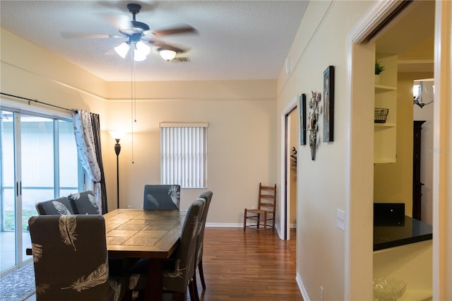 dining space with ceiling fan, a textured ceiling, hardwood / wood-style flooring, and a healthy amount of sunlight