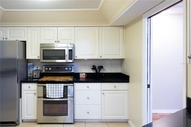 kitchen featuring white cabinetry, tasteful backsplash, light hardwood / wood-style flooring, and appliances with stainless steel finishes