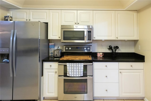 kitchen with white cabinetry, tasteful backsplash, and stainless steel appliances