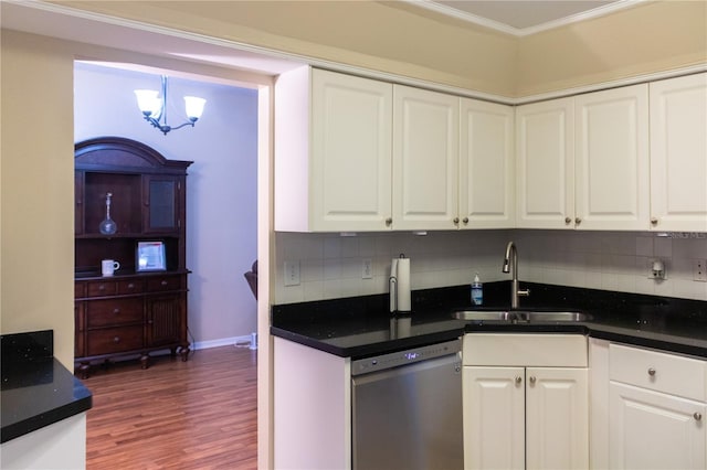 kitchen with sink, stainless steel dishwasher, decorative backsplash, white cabinetry, and hardwood / wood-style flooring