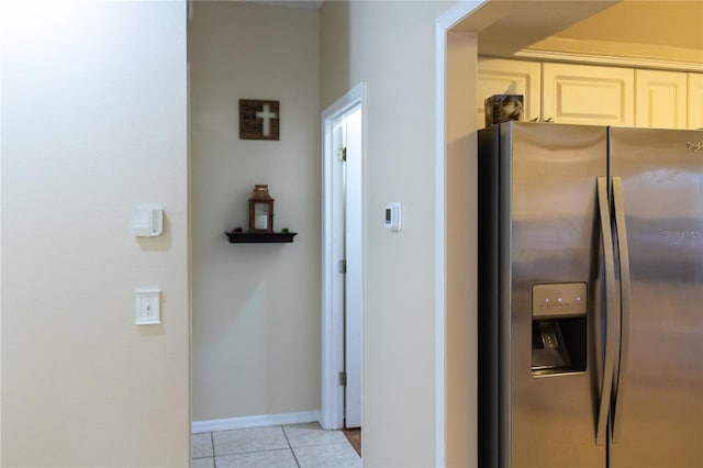 kitchen with light tile patterned floors and stainless steel fridge with ice dispenser