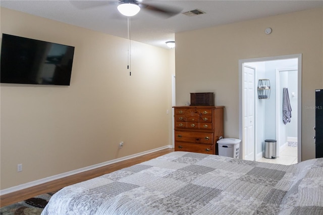 bedroom featuring wood-type flooring, connected bathroom, and ceiling fan