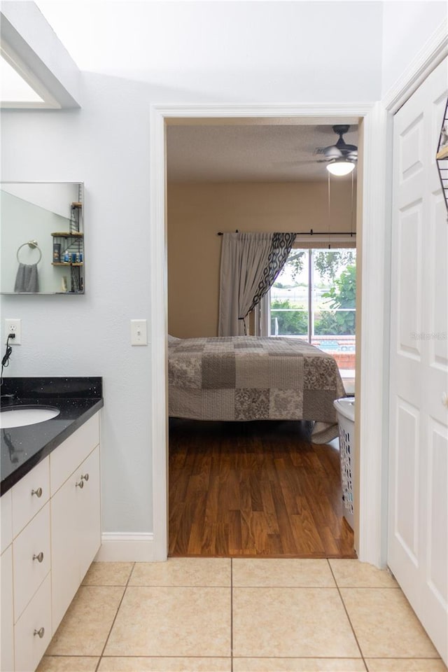 unfurnished bedroom featuring sink, light wood-type flooring, and ceiling fan