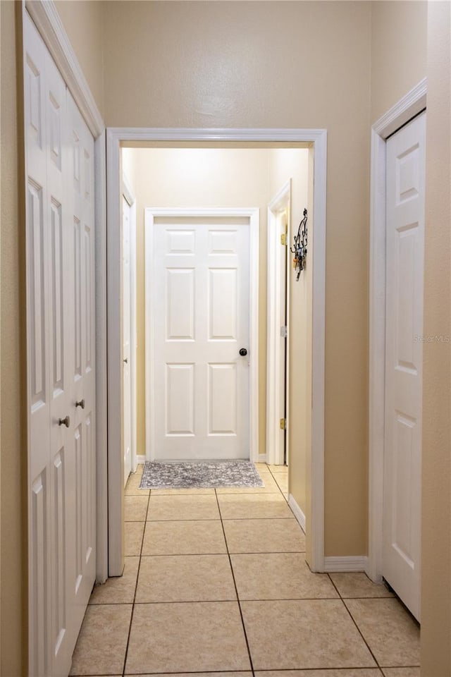 corridor featuring light tile patterned flooring