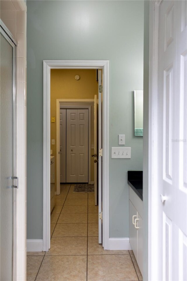 hall featuring light tile patterned floors