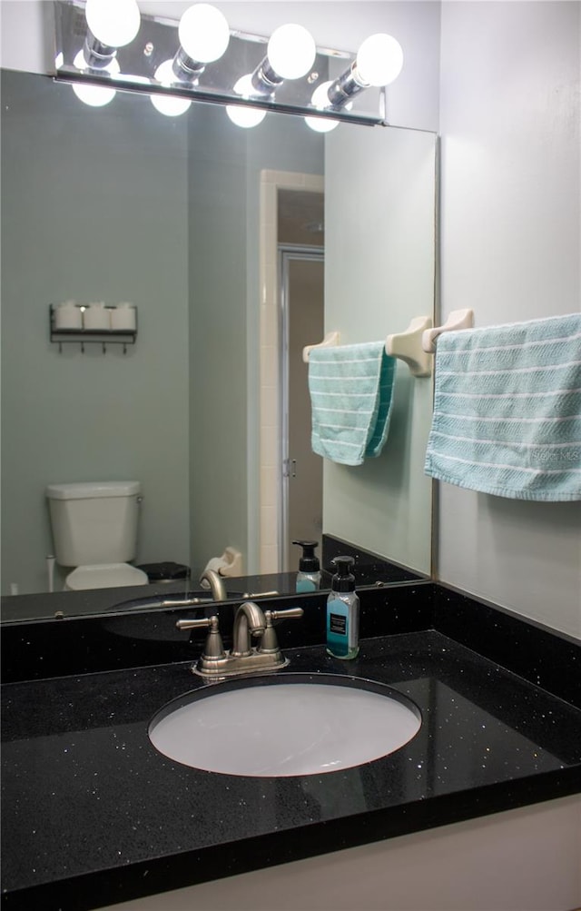 bathroom featuring toilet and vanity