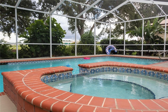 view of swimming pool with pool water feature and glass enclosure