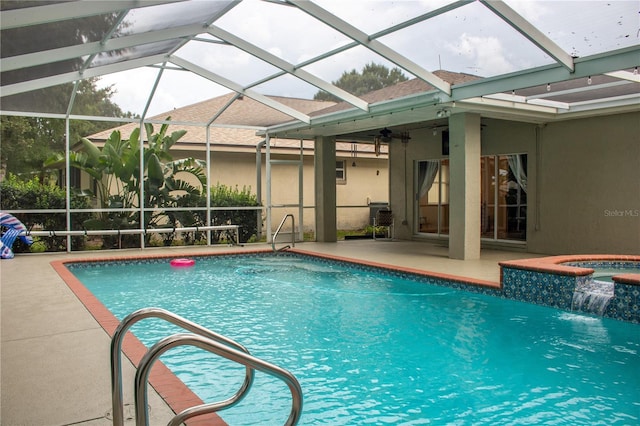 view of swimming pool featuring a patio, an in ground hot tub, pool water feature, and a lanai