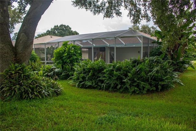 view of yard featuring glass enclosure