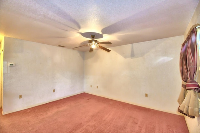 unfurnished room with ceiling fan, a textured ceiling, and carpet