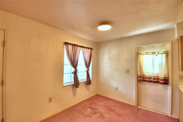 unfurnished bedroom with a textured ceiling, a closet, and carpet floors