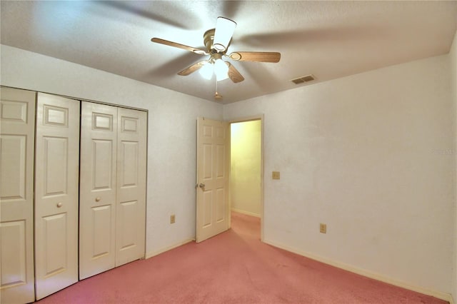 unfurnished bedroom featuring ceiling fan, carpet flooring, and a closet