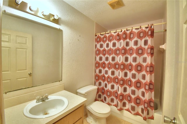 full bathroom with shower / tub combo with curtain, vanity, a textured ceiling, and toilet