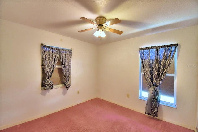 unfurnished room with ceiling fan and carpet flooring