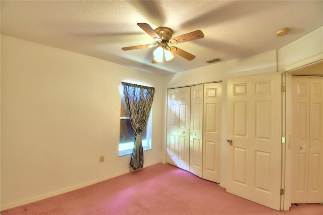 unfurnished bedroom featuring ceiling fan and carpet