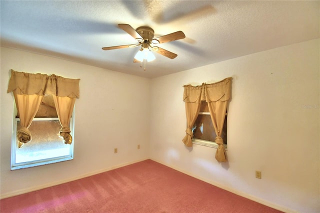 carpeted spare room featuring ceiling fan and a textured ceiling