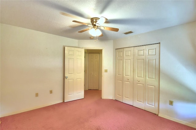 unfurnished bedroom featuring ceiling fan, carpet flooring, and a closet