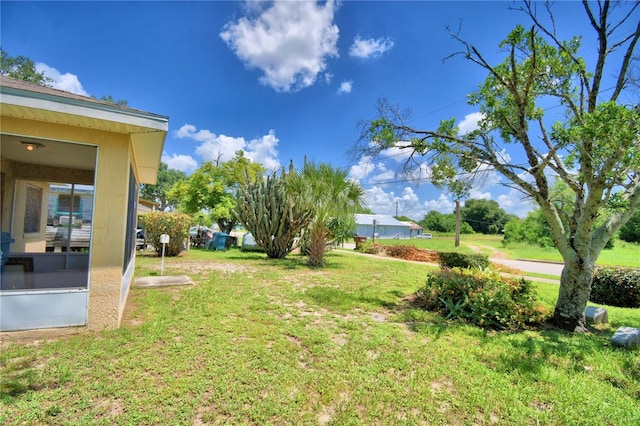 317 C St, Lake Wales, FL 33853 - view of green lawn with a sunroom