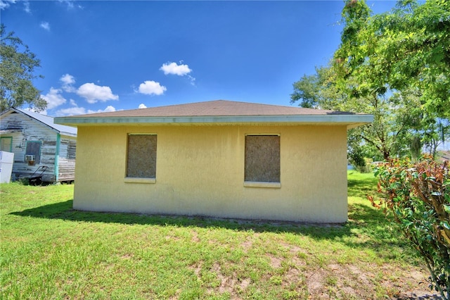 317 C St, Lake Wales, FL 33853 - view of side of property featuring stucco siding and a lawn