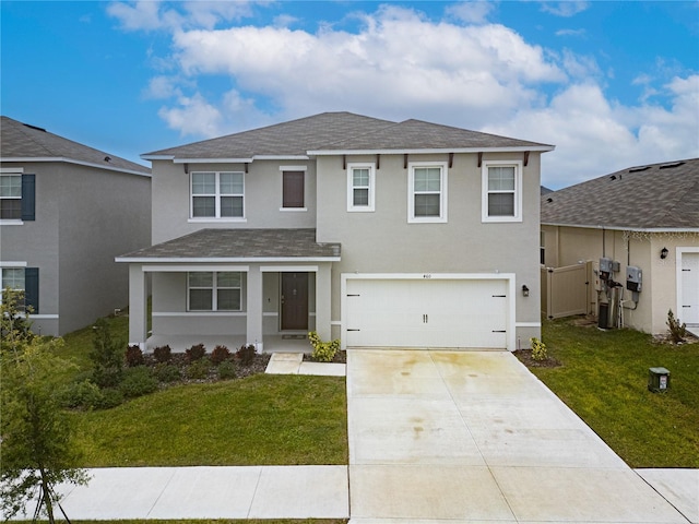 view of front of property with a front yard and a garage