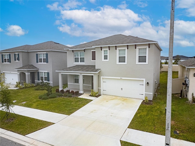 view of front of property with a front yard and a garage