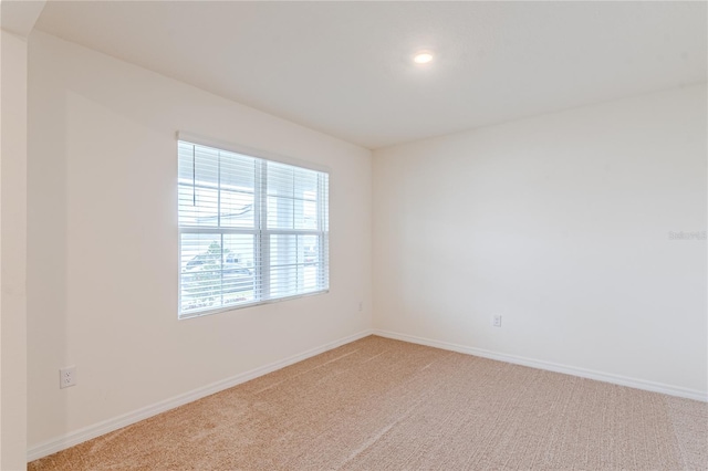 carpeted spare room featuring a healthy amount of sunlight