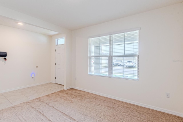 empty room featuring light tile patterned floors and a wealth of natural light