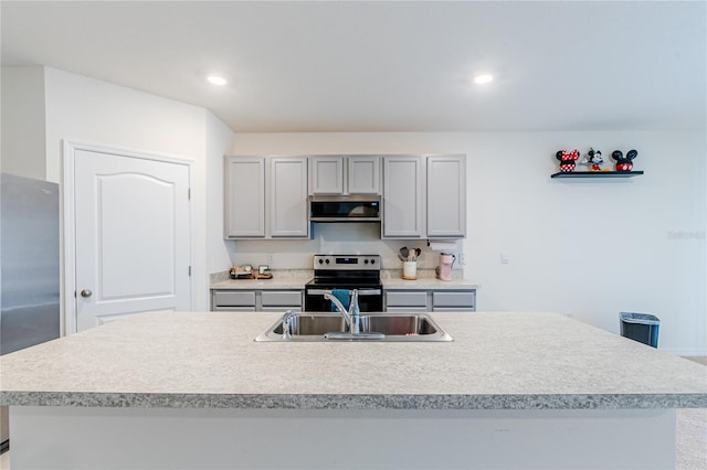 kitchen with appliances with stainless steel finishes, a kitchen island with sink, range hood, and sink