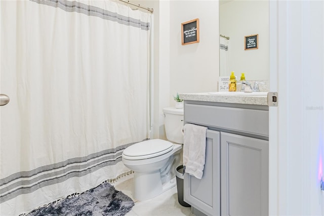 bathroom featuring toilet, tile patterned floors, and vanity