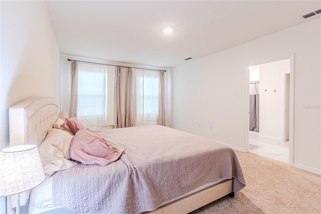 tiled bedroom featuring ensuite bath