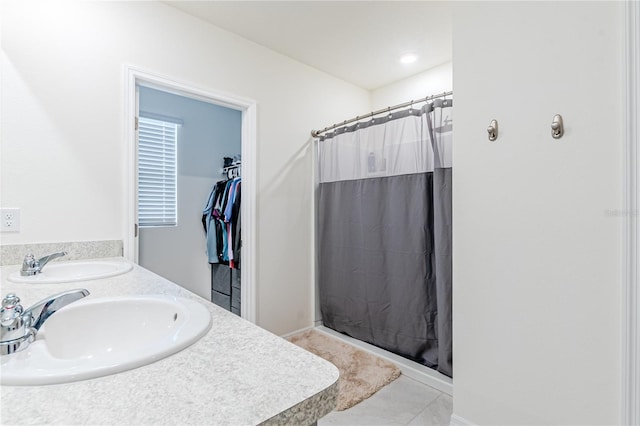 bathroom featuring dual bowl vanity and tile patterned flooring