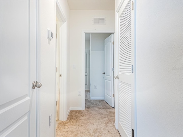 corridor with light colored carpet