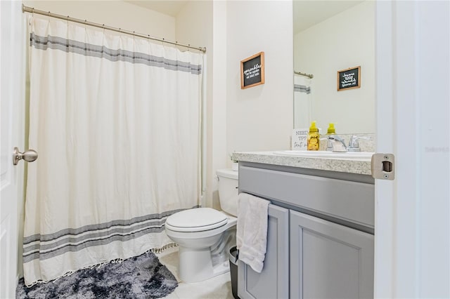 bathroom featuring toilet, tile patterned floors, and vanity