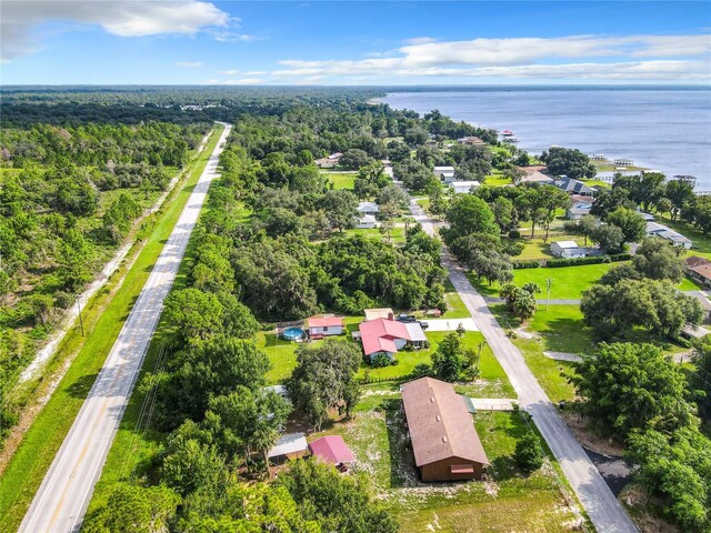 bird's eye view with a water view and a wooded view