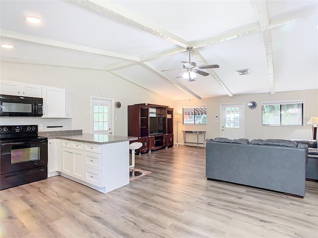 kitchen with vaulted ceiling with beams, a peninsula, white cabinetry, open floor plan, and black appliances