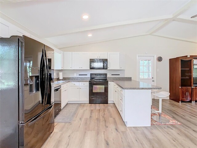 kitchen with vaulted ceiling with beams, a peninsula, a breakfast bar, light wood-type flooring, and black appliances