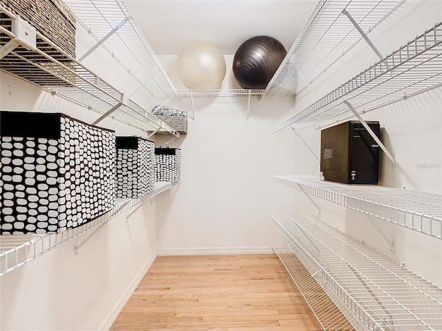 spacious closet with wood finished floors