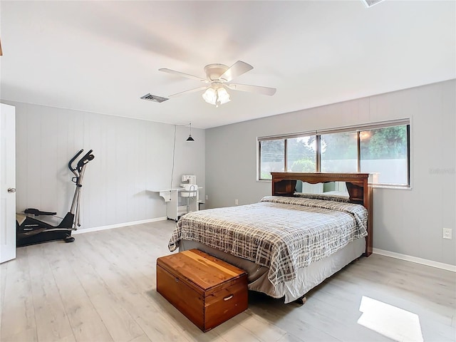 bedroom with a ceiling fan, baseboards, visible vents, and light wood finished floors