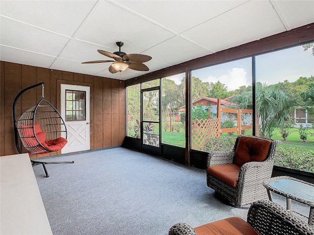 sunroom / solarium with a ceiling fan