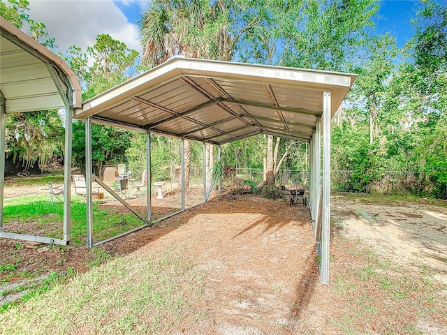 view of yard featuring fence and a carport