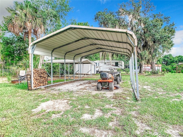 view of car parking featuring a detached carport, driveway, and a storage unit