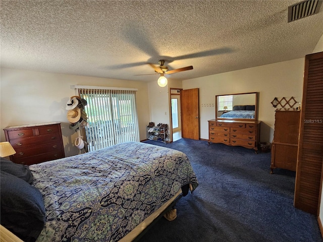 carpeted bedroom with ceiling fan and a textured ceiling