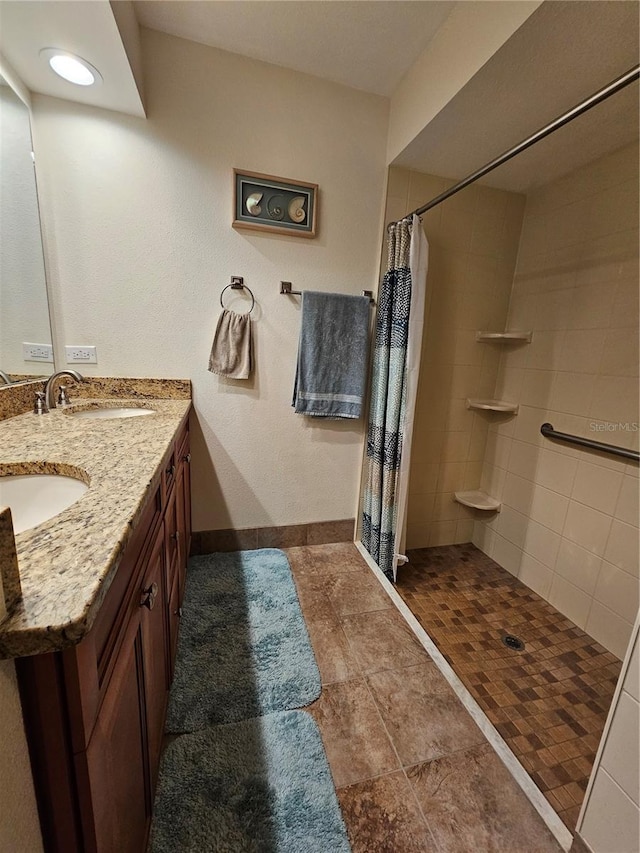 bathroom with a shower with shower curtain, vanity, and tile patterned floors