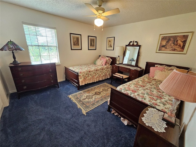 bedroom with a textured ceiling, dark carpet, and ceiling fan