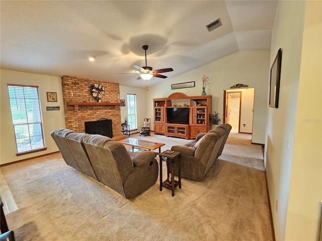 living room featuring ceiling fan, a fireplace, light carpet, and vaulted ceiling