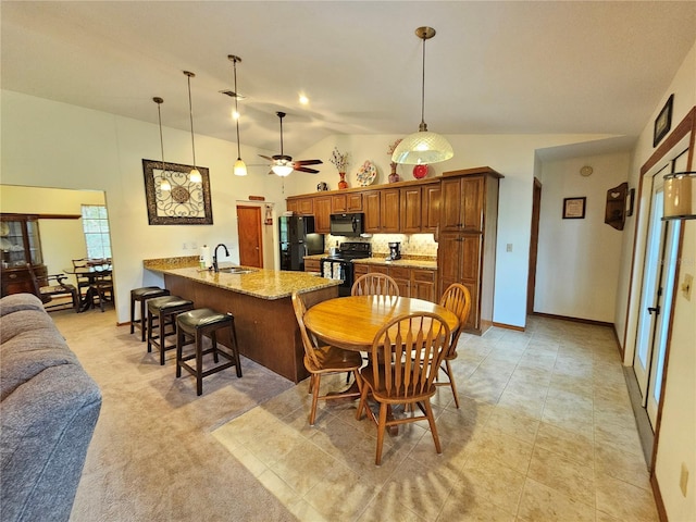 tiled dining space with high vaulted ceiling, ceiling fan, and sink