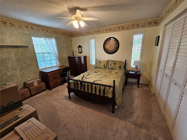 carpeted bedroom featuring a textured ceiling, a closet, and ceiling fan