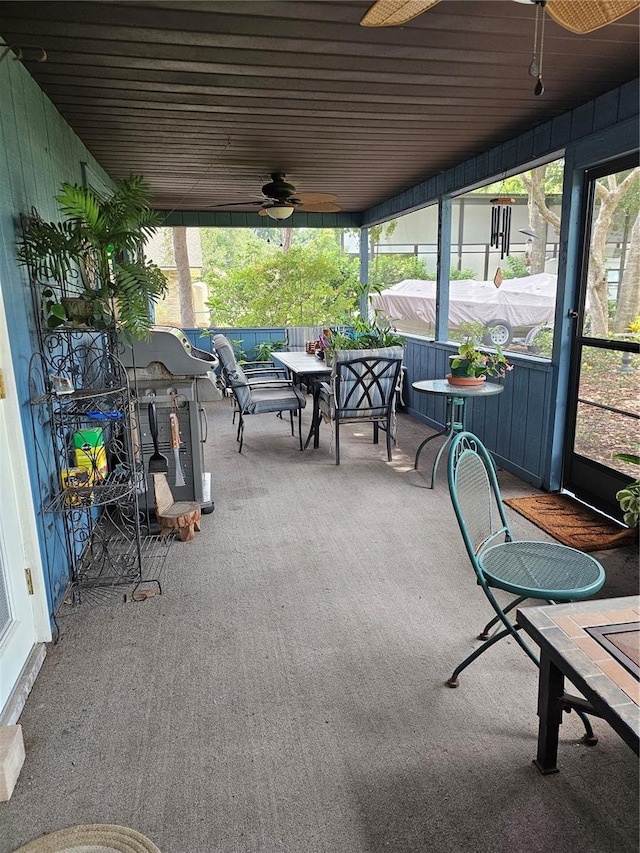 sunroom featuring ceiling fan