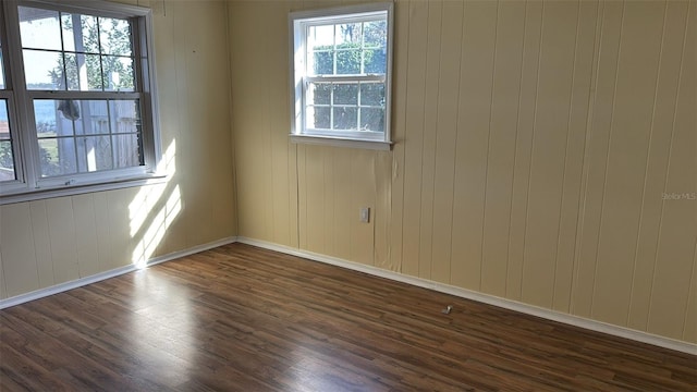 unfurnished room with dark hardwood / wood-style floors