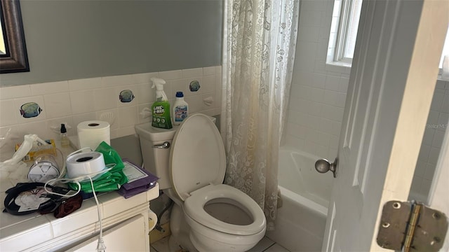 bathroom featuring shower / bath combo, tile walls, and toilet